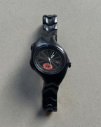 Black track wristwatch with unique Y2K design on a gray background